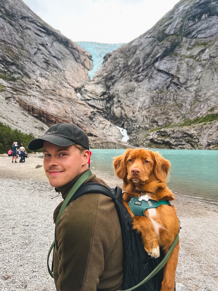 Vilfred on a hike with his dog by a glacial lake